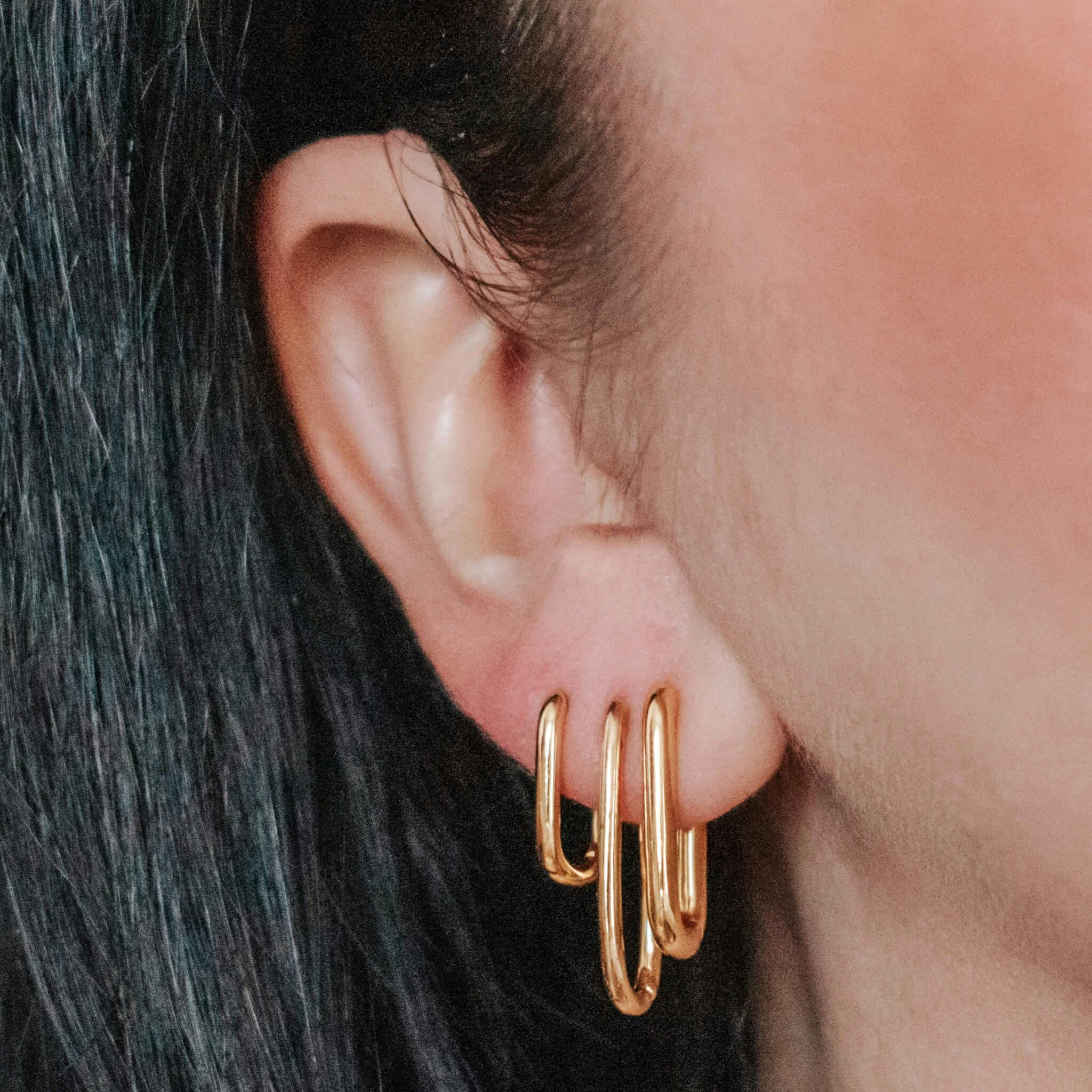 Baby Halo Oval Hoop Earrings in Titanium (Gold) on model