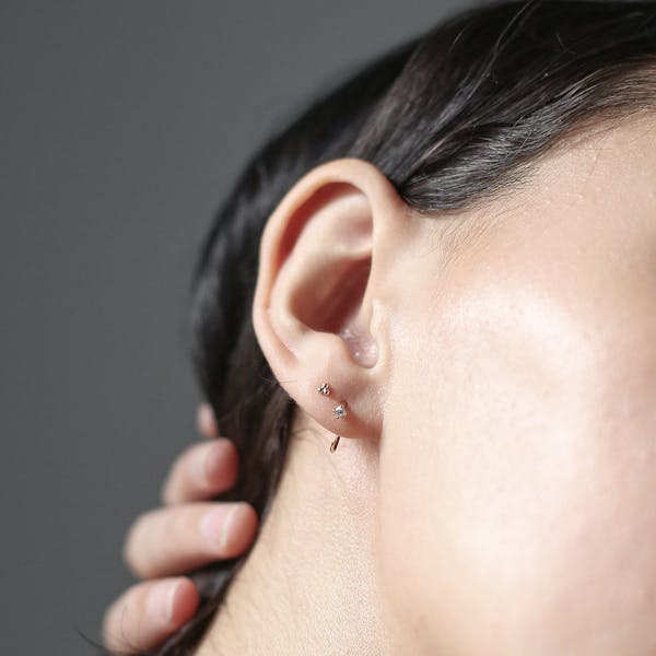Tiny Trinity Studs in Sterling Silver on model