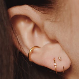 Dewdrop Huggie Earrings in 14k Gold on model