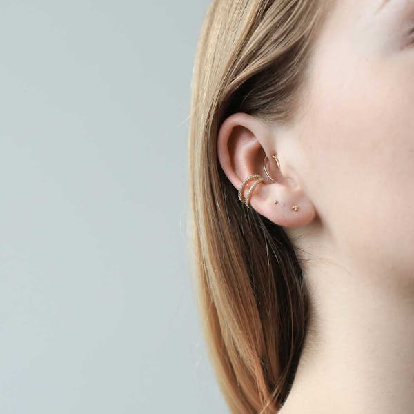 Tiny Trinity Studs in Sterling Silver on model