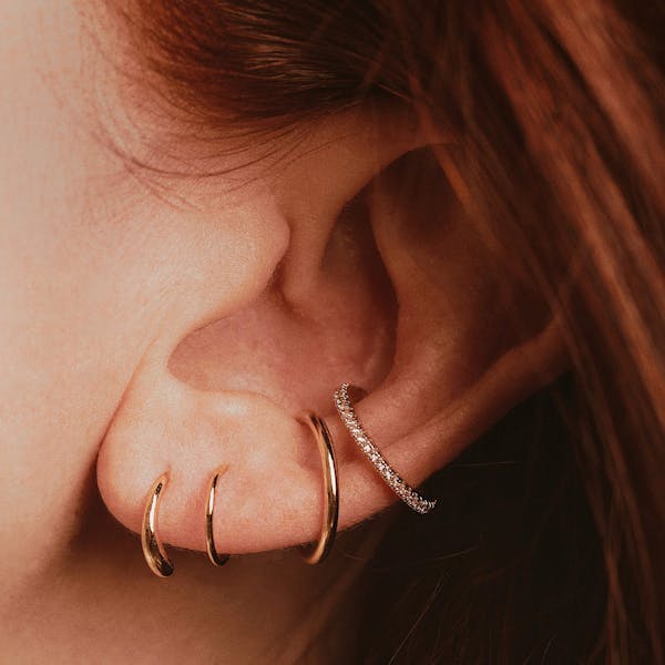 Classic Twirl Earrings in Titanium on model (Gold)
