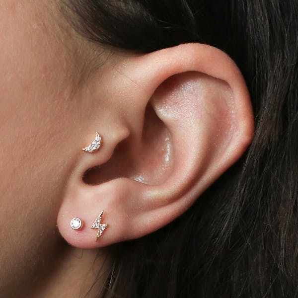 Tiny Crystal Studs in Titanium on model (Gold)