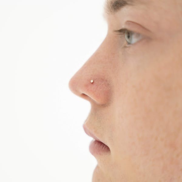 Tiny Diamond Stud L-Shape Nose Ring in 14k Gold on model